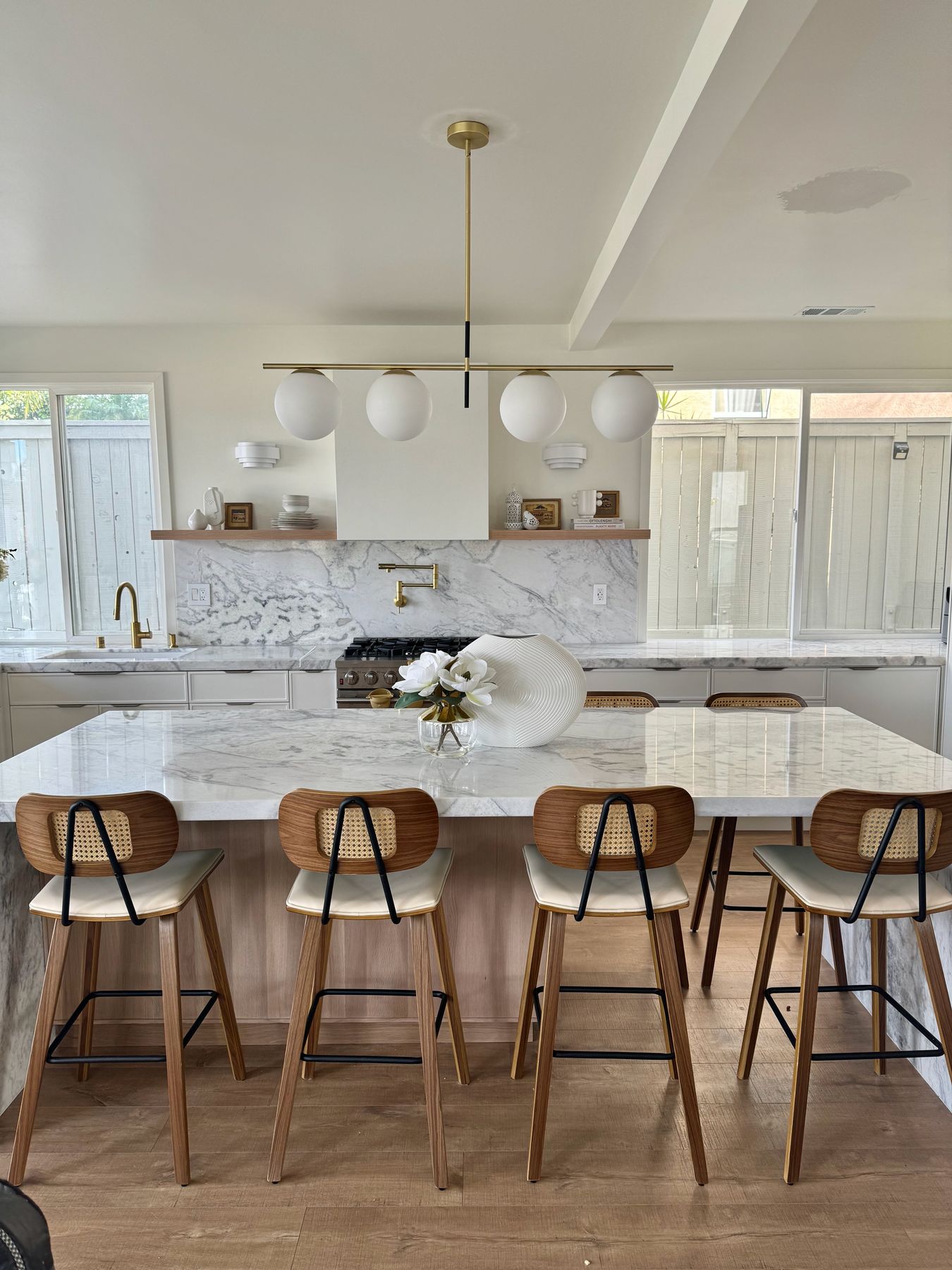 Carmel Mountain kitchen with a marble waterfall island by Antoon Construction Services