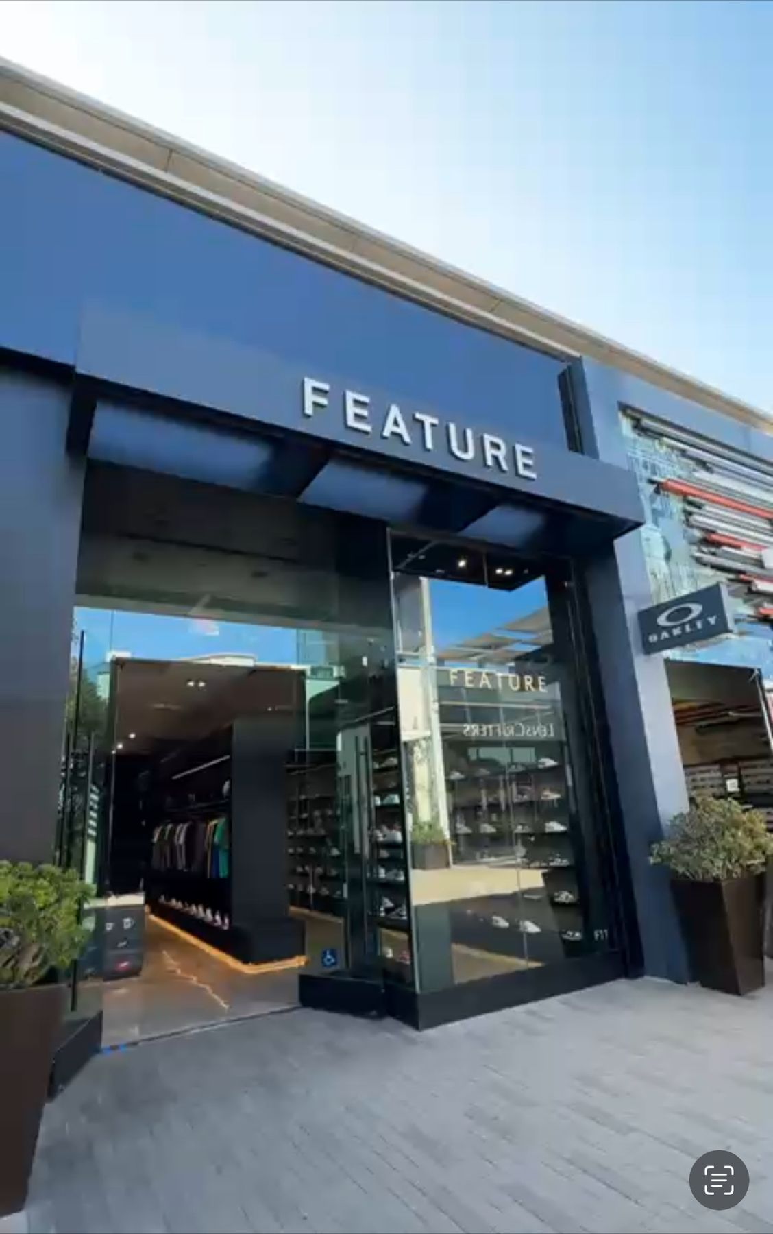 Feature sneaker store exterior with a dark storefront frame and glass entry at UTC in San Diego