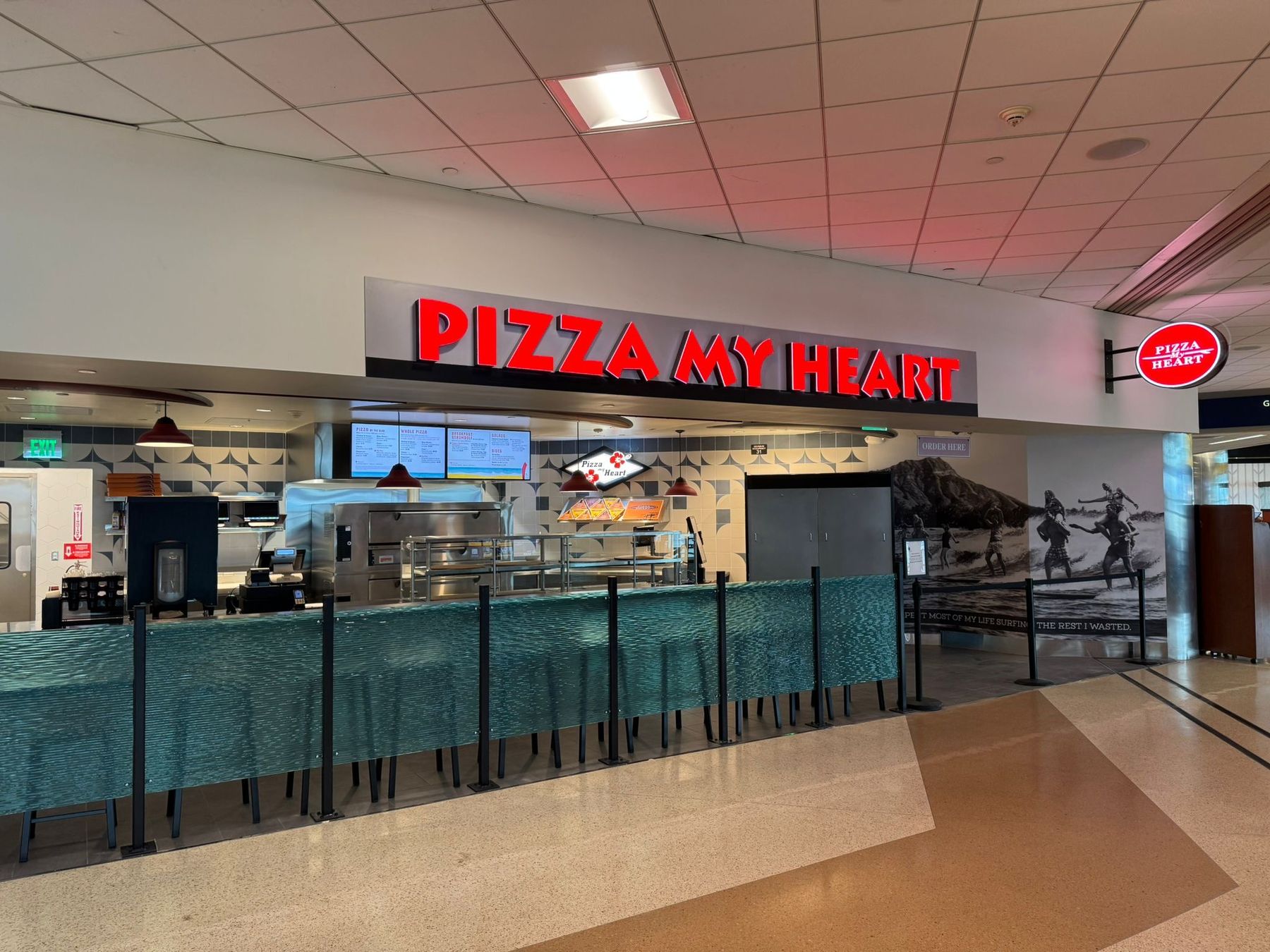 Pizza My Heart storefront with illuminated red signage at San José Mineta International Airport