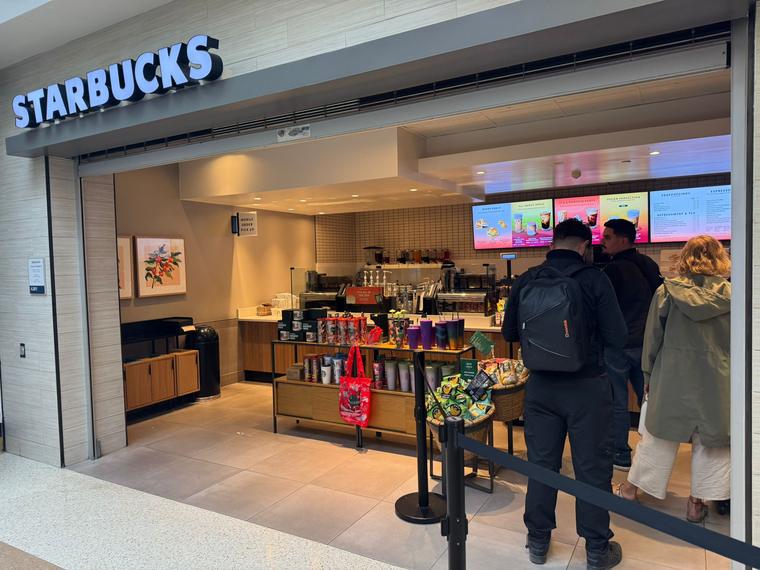 Starbucks storefront with merchandise displays in Terminal A at San José airport