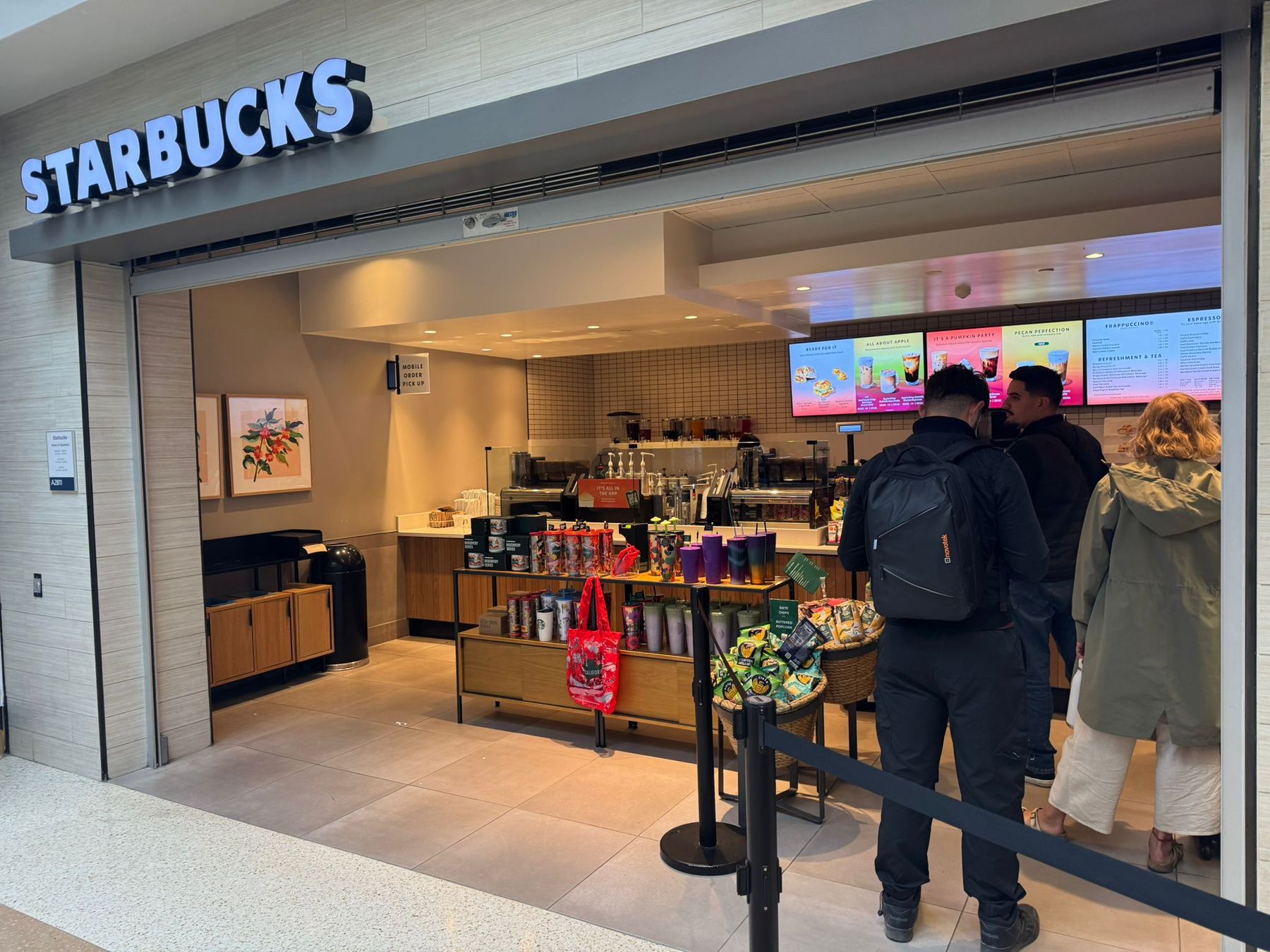 Starbucks storefront with merchandise displays in Terminal A at San José airport